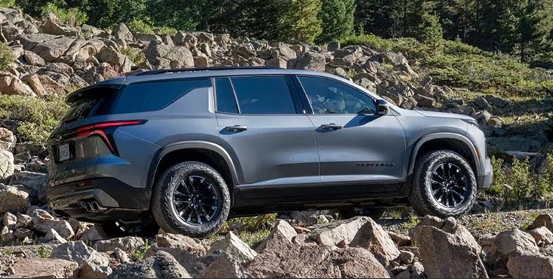 A 2026 Chevrolet Traverse off-roading up a rocky road.