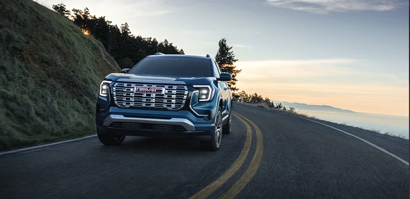 A 2026 GMC Terrain driving down the road.